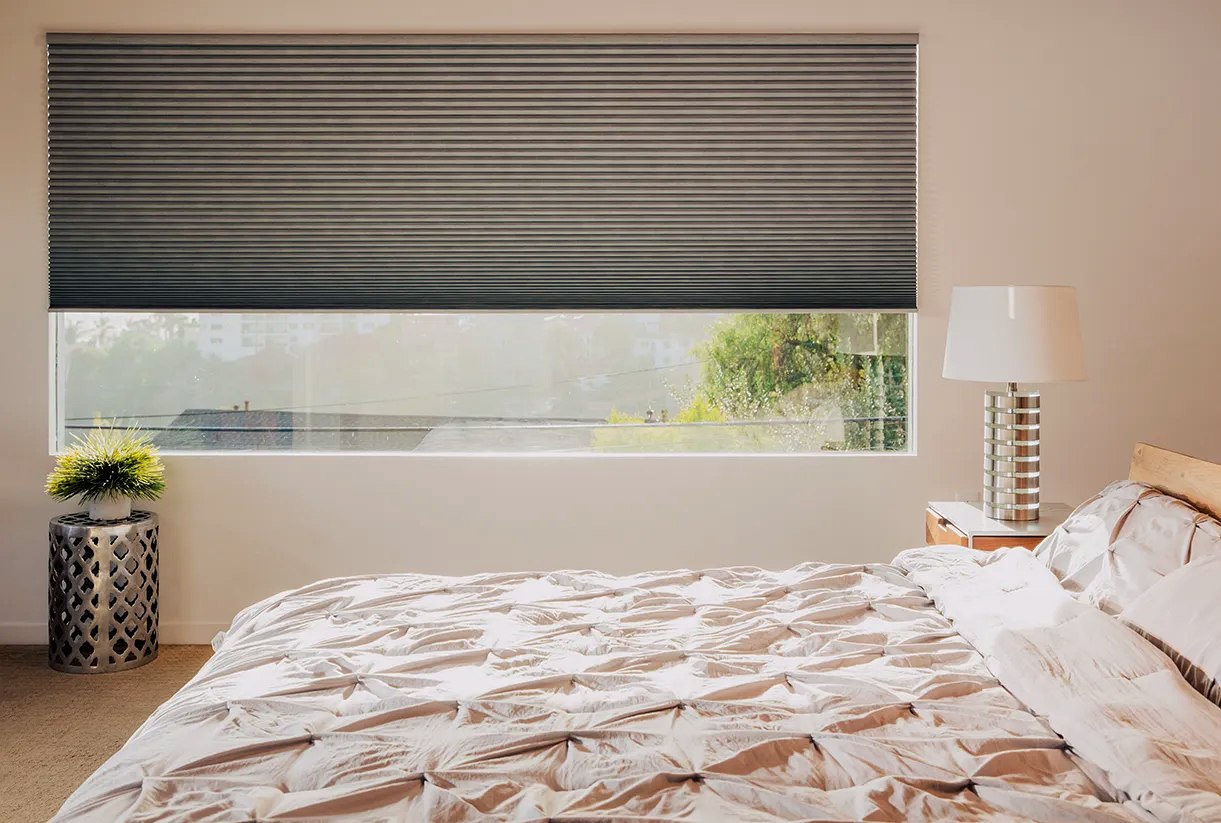 Dark cellular shade over bedroom window